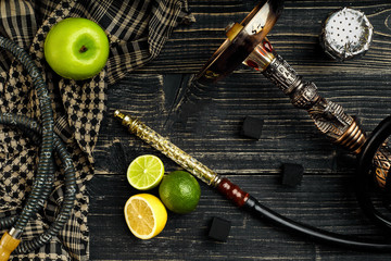 Dismantled parts of hookah on a wooden background with lime and 