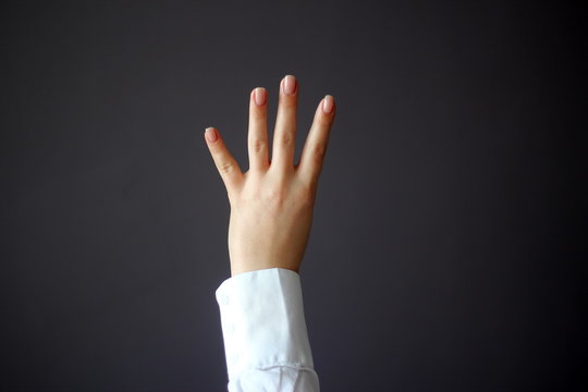 Young Woman's Hand Shows Four Fingers or Shows Direction Gesture