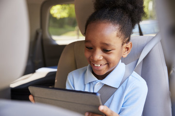 Boy Using Digital Tablet On Car Journey