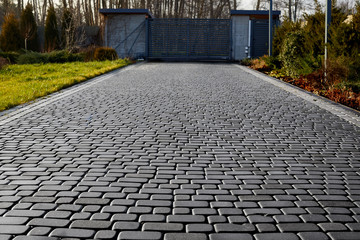 Cobblestone entrance in the garden, graphite paving stone texture, pavement