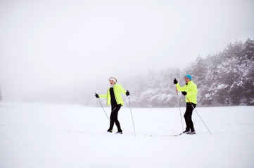 Fototapeta na wymiar Senior couple cross-country skiing.