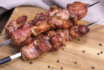fried pieces of pork on skewers