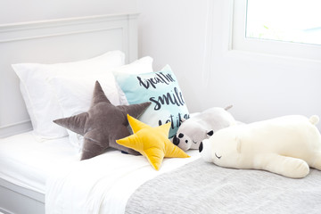 Star pillows and square pillows on wooden beds