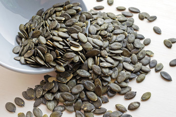 fresh pumpkin seeds in ceramic plate