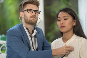 doctor checking patient's vitals