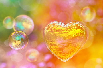 Soap bubble in the shape of a heart, colorful background, love and Valentine's day greeting card
