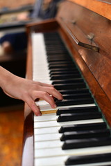 Fototapeta premium Top view of young woman in white dress playing the piano. Music background