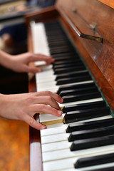 Top view of young woman in white dress playing the piano. Music background