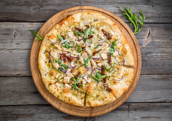 pizza with sun-dried tomatoes, prosciutto, arugula and parmesan cheese