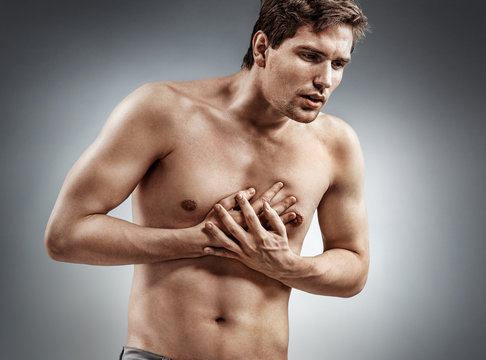 Heart attack. Man holding hands on painful chest. Medical concept.