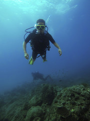 Naklejka na ściany i meble Thailand, Pang-nga, Kho Lak, 3rd Jan'18. Kho Na Yak. Student for diving open water course with diving gear (equipment) practicing diving in the deep blue sea surrounding by brown corals. Editorial.