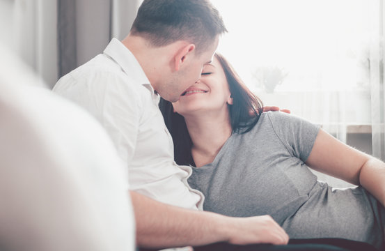 Cheerful pregnant couple relaxing at home and enjoying pregnancy time