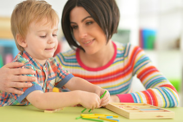 Young mother playing with son