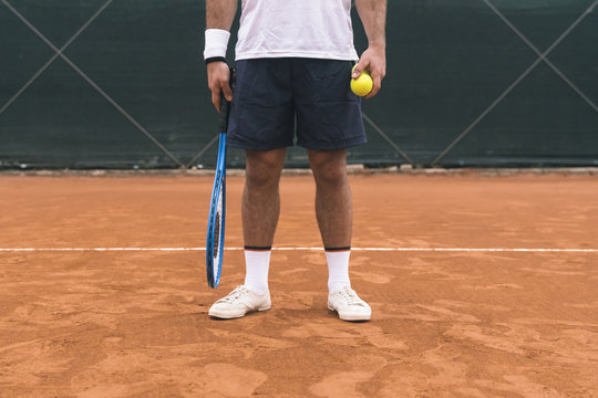 Detail of a tennis player during a game on a clay court