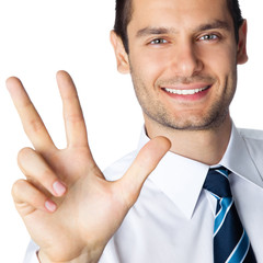 Businessman showing three fingers, isolated