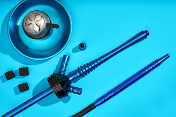 Parts of blue decorated hookah or shisha on light blue backgroun