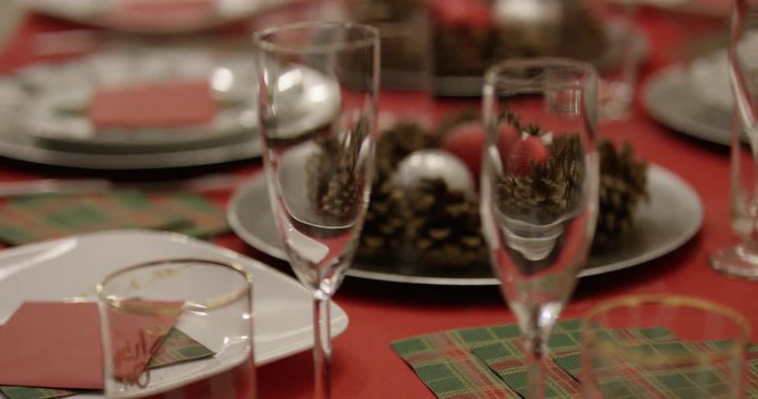 Christmas dinner place setting - rack focus on champagne glasses