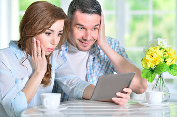 young couple looking at digital tablet