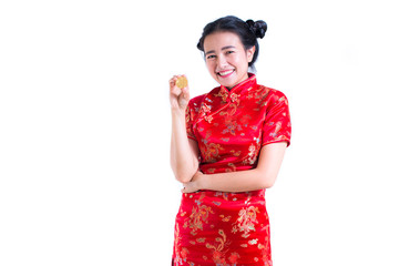 Beautiful Young asian woman wearing chinese dress traditional cheongsam or qipao with hand holding golden Bitcoin isolated on white background. Chinese New Year Festivities, Electronic money concept