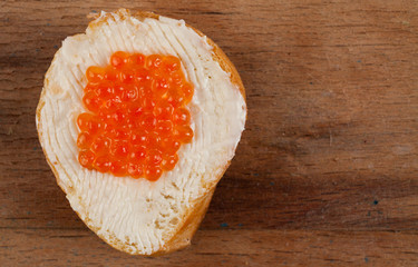 Butter with red caviar close up