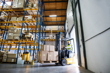 Warehouse man worker with forklift.
