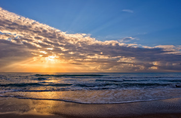 Fototapeta na wymiar A sunrise in the mediterranean sea with the sun in the background