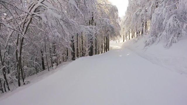 A skier skiing on the tracks in mountains, gopro footage