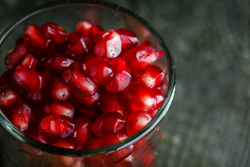 Ripe pomegranate seeds in a tiny glass