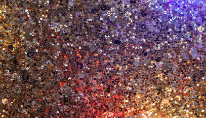 sequins reflecting coloured lights background