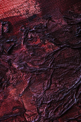 Dark contrast ruby coloured canvas and fabric abstract background