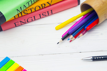 Education concept. Studying for exams. A stack os student's books and a pencilcase with colored...