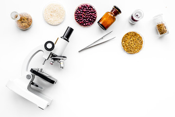 Food safety. Wheat, rice and red beans near microscope on white background top view copy space