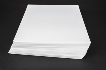 New unused office paper on black background