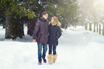 Fototapeta na wymiar Happy Young Couple in Winter Park