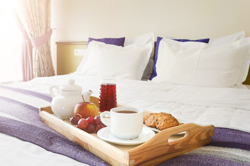 Fototapeta na wymiar Breakfast served in bed on wooden tray