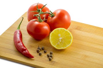 Red hot chili pepper and fresh red tomatoes with lemon