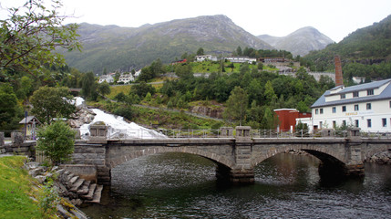 Scenic view of a bridge near the waterfall, village Hellesylt, mountain in the background, More og Romsdal, Norway