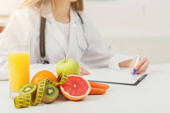 Nutritionist desk with fruit and measuring tape