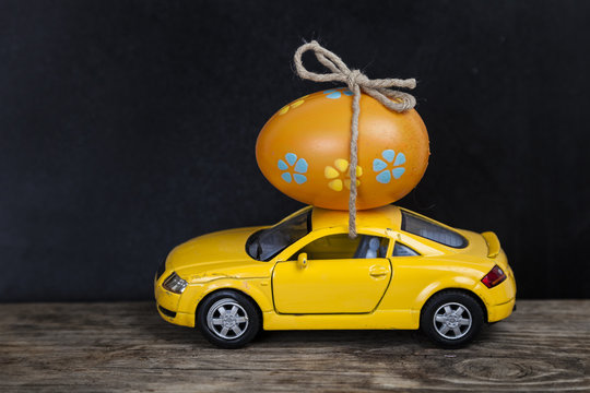 Yellow toy car with easter egg.