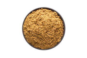 ground nutmeg powder in clay bowl isolated on white background. Seasoning or spice top view