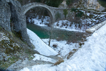 Fototapeta na wymiar bridge old in Ioannina Zagori Greeece snow ice winter time