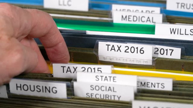 Home filing system for taxes organized in folders