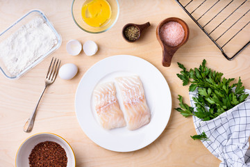 Fototapeta na wymiar Cod fish fillets with cooking ingredients. Top view,