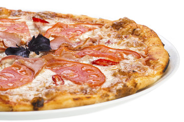 Tasty pizza with ham and tomato