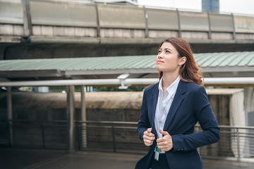 Portraits of beautiful asian woman look cheerful and confidence is standing in outdoors while feeling success with work.