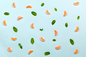 Healthy food fruits pattern with orange mandarin cloves, green mint leafs and orange slices isolated on azure blue background