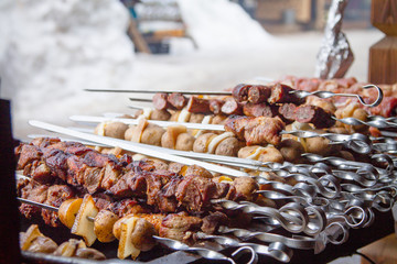 pieces of meat, lard and potatoes strung on shaprur. Shish kebab traditional dish