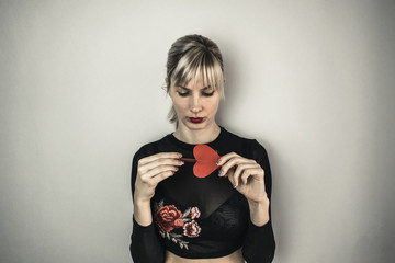 Beautiful girl holding paper heart