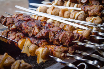 pieces of meat, lard and potatoes strung on shaprur. Shish kebab traditional dish