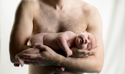 Newborn Baby in hands of dad -  happy family moments of parents with their children. Beautiful time in life.